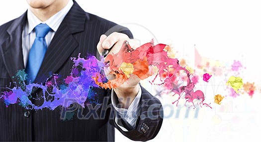 Businessman against white background drawing colorful splashes with marker Businessman against white background drawing colorful splashes with marker