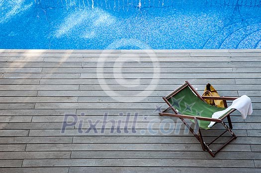 Wooden sundeck and a lonely deck chair