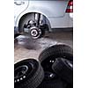 inside a garage - changing wheels/tires (shallow DOF; color toned image)