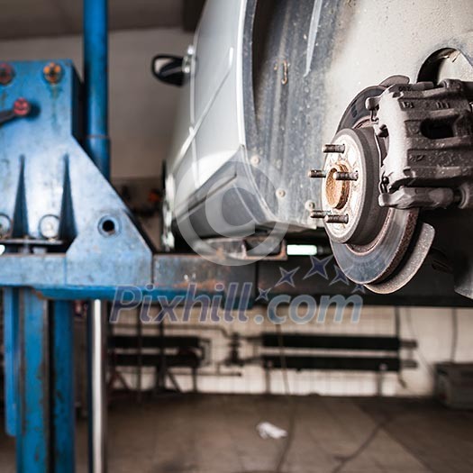 Inside a garage - changing wheels/tires (shallow DOF; color toned image)