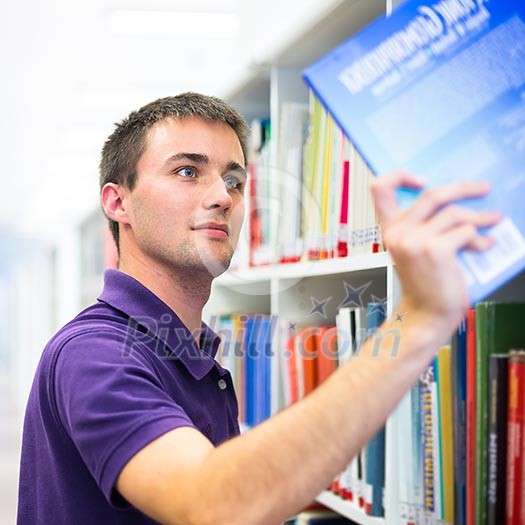 Handsome college student in library (shallow DOF; color toned image) Handsome college student in library (shallow DOF; color toned image)