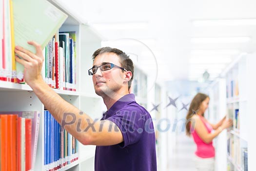 Handsome college student in library (shallow DOF; color toned image) Handsome college student in library (shallow DOF; color toned image)