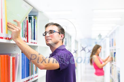 Handsome college student in library (shallow DOF; color toned image)