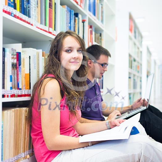 Two college students in library (color toned image; shallow DOF)