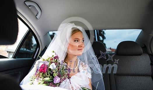 Portrait of a beautiful young bride waiting in the car on her way to the wedding ceremony Portrait of a beautiful young bride waiting in the car on her way to the wedding ceremony