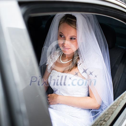 Portrait of a beautiful young bride waiting in the car on her way to the wedding ceremony Portrait of a beautiful young bride waiting in the car on her way to the wedding ceremony