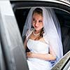 Portrait of a beautiful young bride waiting in the car on her way to the wedding ceremony