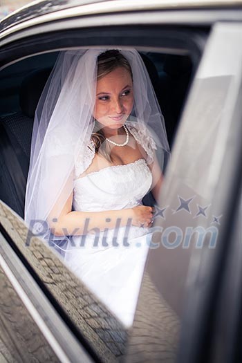Portrait of a beautiful young bride waiting in the car on her way to the wedding ceremony Portrait of a beautiful young bride waiting in the car on her way to the wedding ceremony