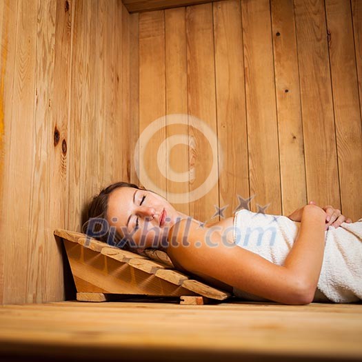 Young woman relaxing in a sauna Young woman relaxing in a sauna