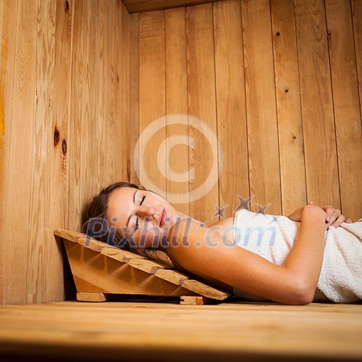 Young woman relaxing in a sauna