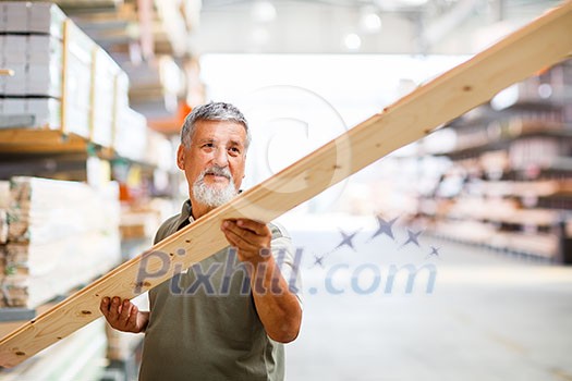 Senior man buying construction wood in a  DIY store