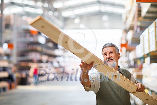 Senior man buying construction wood in a DIY store Senior man buying construction wood in a DIY store