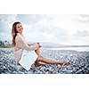 Young woman on the beach enjoying a warm summer evening