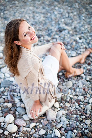 Young woman on the beach enjoying a warm summer evening Young woman on the beach enjoying a warm summer evening