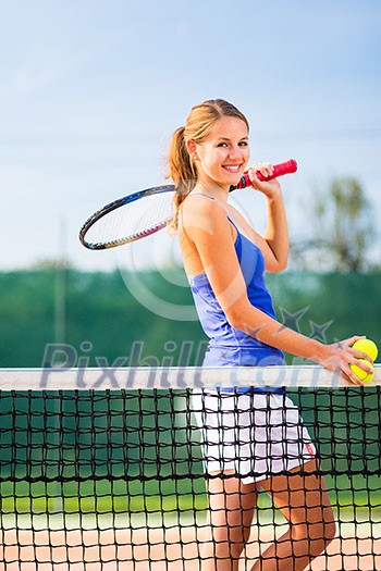 Portrait of a pretty young tennis player with copyspace