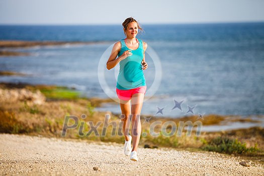 Young woman on her evening jog along the seacoast Young woman on her evening jog along the seacoast