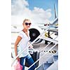 Departure - young woman at an airport about to board an aircraft on a sunny summer day