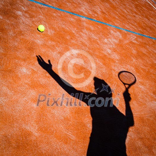 shadow of a tennis player in action on a tennis court (conceptual image with a tennis ball lying on the court and the shadow of the player positioned in a way he seems to be playing it) shadow of a tennis player in action on a tennis court (conceptual image with a tennis ball lying on the court and the shadow of the player positioned in a way he seems to be playing it)
