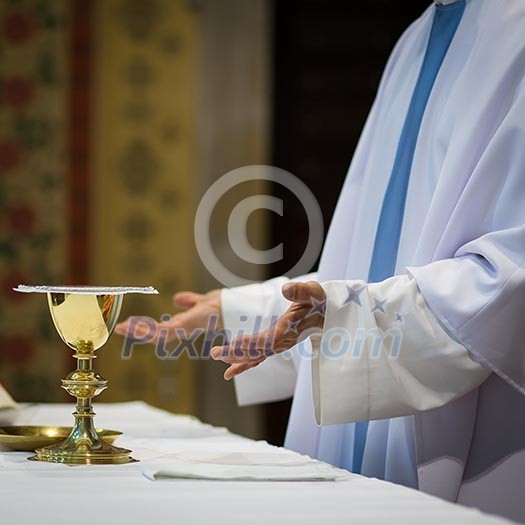 Priest during a wedding ceremony/nuptial mass Priest during a wedding ceremony/nuptial mass