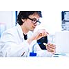 Young male researcher carrying out scientific research in a lab (shallow DOF; color toned image)