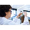 Young male researcher carrying out scientific research in a lab (shallow DOF; color toned image)