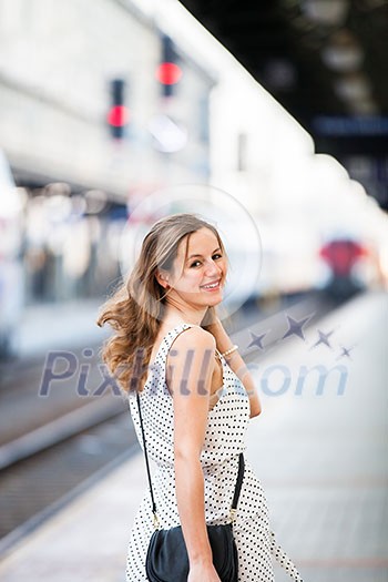 Pretty young woman at a train station