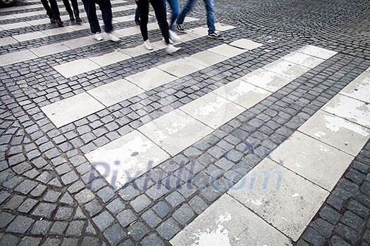 urban traffic concept - city street with a motion blurred crowd crossing a road