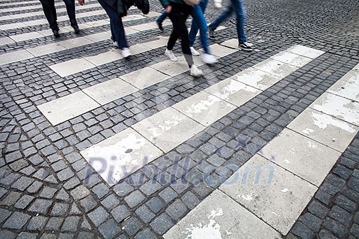 urban traffic concept - city street with a motion blurred crowd crossing a road