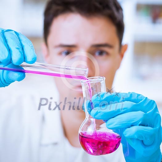 young male researcher carrying out scientific research in a lab (shallow DOF; color toned image) young male researcher carrying out scientific research in a lab (shallow DOF; color toned image)
