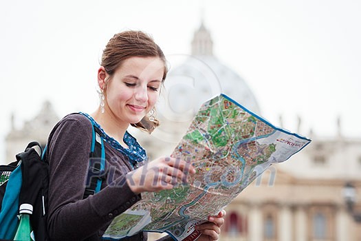 Pretty young female tourist studying a map at St. Peter's square in the Vatican City in Rome Pretty young female tourist studying a map at St. Peter's square in the Vatican City in Rome