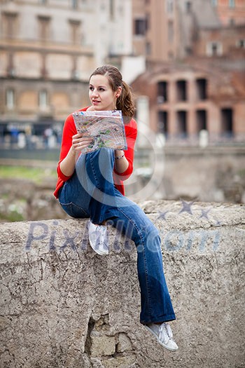 Pretty young female tourist studying a map at the Trajan's forum in Rome, Italy (dome of the Santissimo Nome di Maria church in the background) Pretty young female tourist studying a map at the Trajan's forum in Rome, Italy (dome of the Santissimo Nome di Maria church in the background)