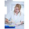 portrait of a female researcher doing research in a lab (color toned image; shallow DOF)