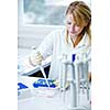 portrait of a female researcher doing research in a lab (color toned image; shallow DOF)