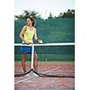 pretty, young female tennis player on the tennis court (shallow DOF, selective focus)