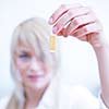 Closeup of a female researcher/chemistry student carrying out experiments in a lab (color toned image)