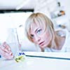 Closeup of a female researcher/chemistry student carrying out experiments in a lab (color toned image)