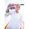 Closeup of a female researcher/chemistry student carrying out experiments in a lab (color toned image)