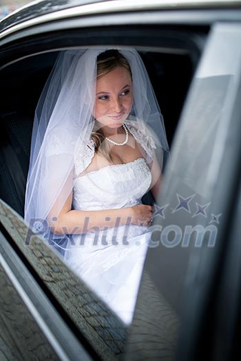 Portrait of a beautiful young bride waiting in the car on her way to the wedding ceremony Portrait of a beautiful young bride waiting in the car on her way to the wedding ceremony