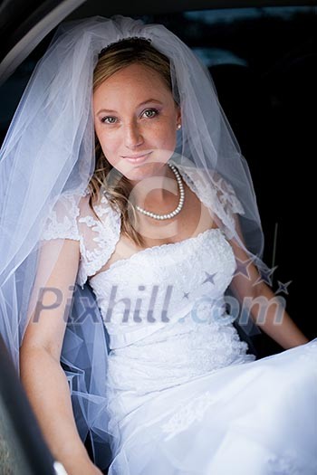 Portrait of a beautiful young bride waiting in the car on her way to the wedding ceremony Portrait of a beautiful young bride waiting in the car on her way to the wedding ceremony