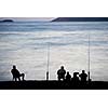 Sea/Ocean fishing - fishermen sitting by the sea/ocean in darkness waiting for the catch