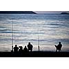 Sea/Ocean fishing - fishermen sitting by the sea/ocean in darkness waiting for the catch