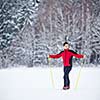 Cross-country skiing: young man cross-country skiing on a lovely snowy winter day