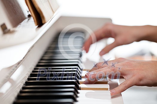 Playing Piano (shallow DOF; color toned image) Playing Piano (shallow DOF; color toned image)