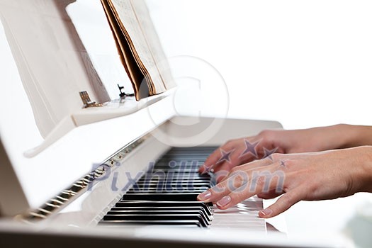Playing Piano (shallow DOF; color toned image) Playing Piano (shallow DOF; color toned image)