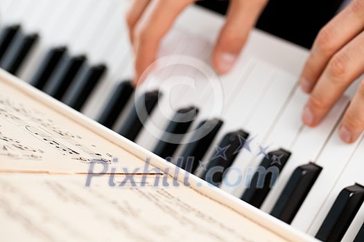 Playing Piano (shallow DOF; color toned image) Playing Piano (shallow DOF; color toned image)