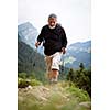 Active senior hiking in high mountains (Swiss Alps)