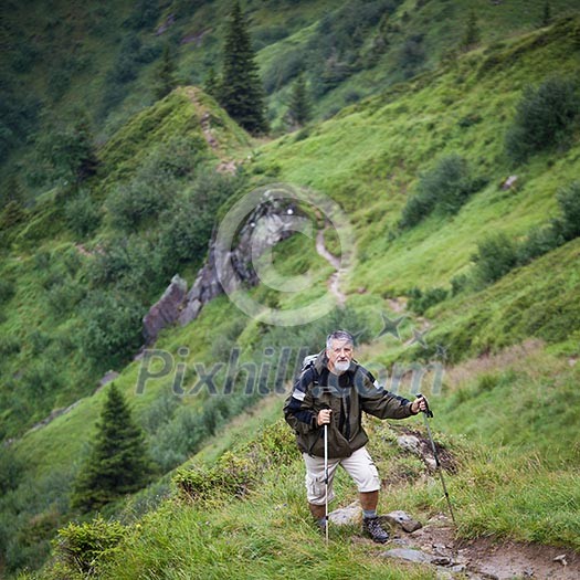 Active senior hiking in high mountains (Swiss Alps)