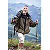 Active senior hiking in high mountains (Swiss Alps)