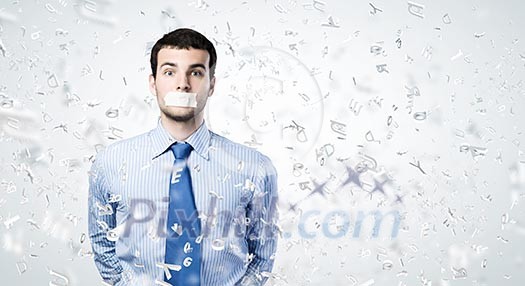 Young handsome businessman with adhesive tape on mouth