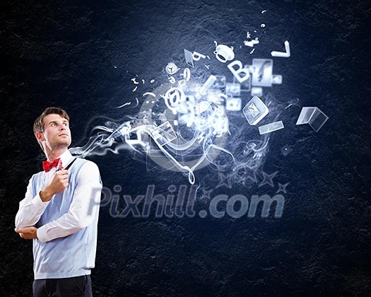 Young handsome businessman in fumes smoking pipe Young handsome businessman in fumes smoking pipe